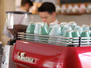 Cafe Partnerships a barista serving coffee